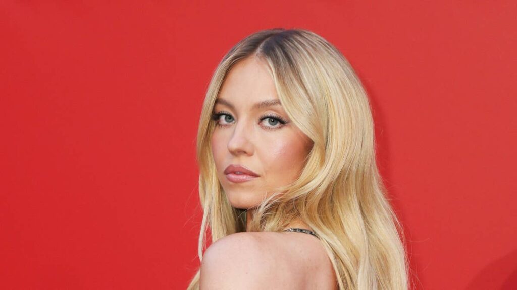 Sydney Sweeney channels Pamela Anderson in plunging red swimsuit on romantic getaway with Scooter Braun