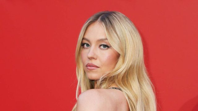Sydney Sweeney channels Pamela Anderson in plunging red swimsuit on romantic getaway with Scooter Braun