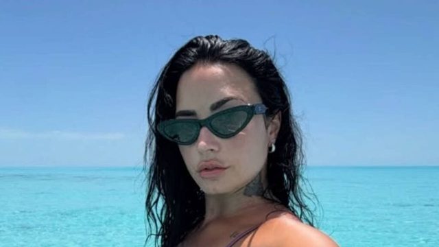 Demi Lovato shows off tattoos in tiny string bikini