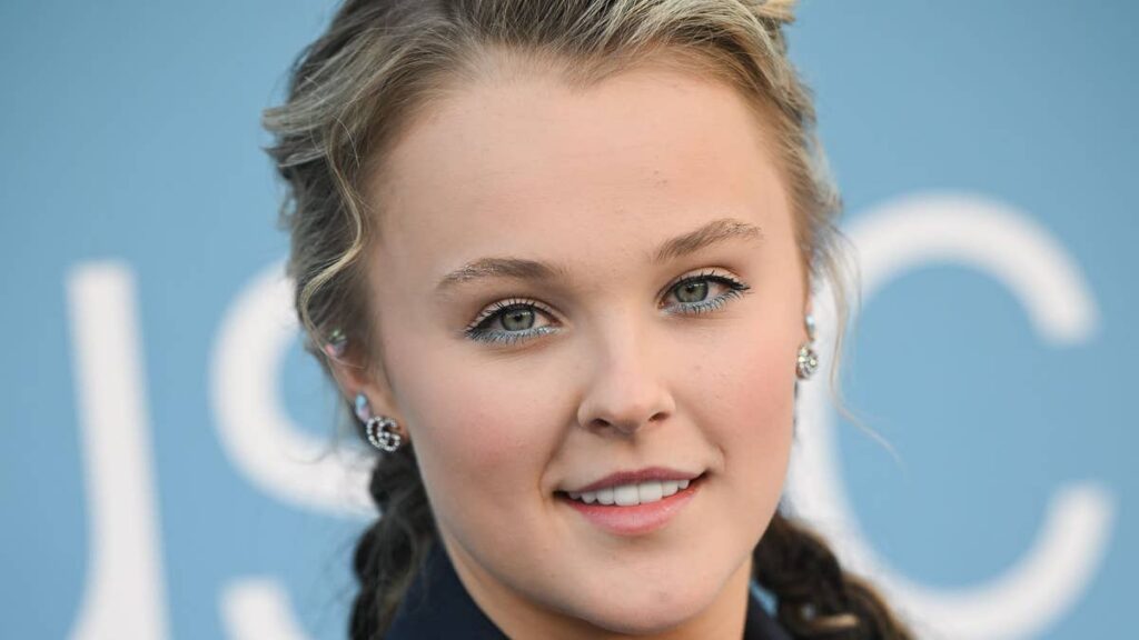 JoJo Siwa strips down for loved-up pool moment with Chris Hughes in intimate new photos