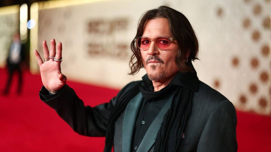 Johnny Depp’s Las Vegas photo call takes an unexpected turn as he bites into the backdrop
