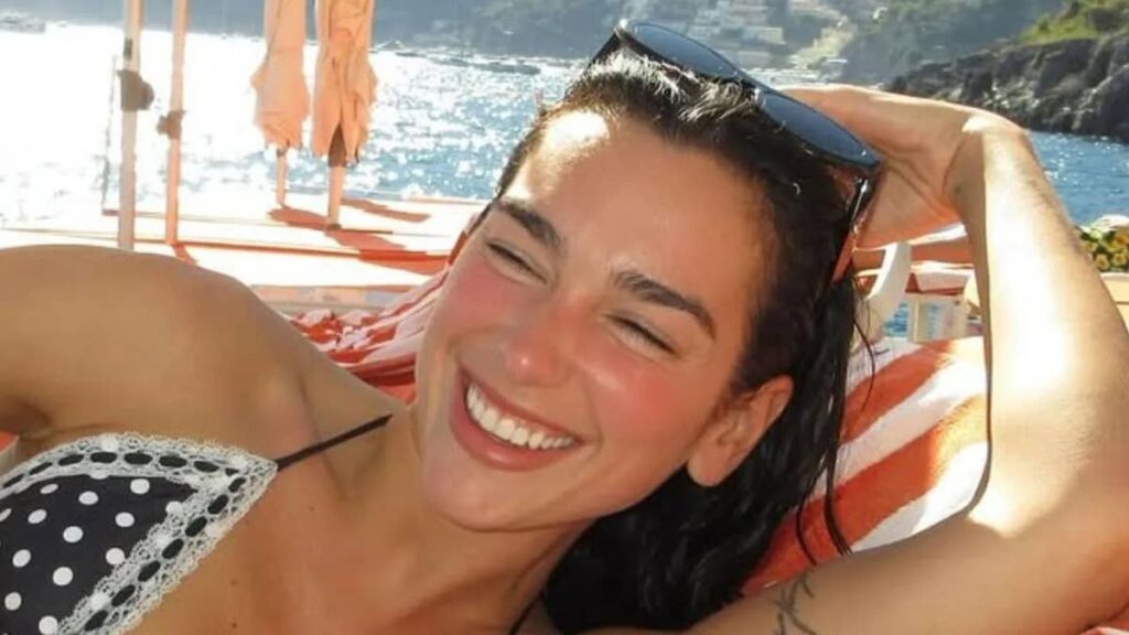 Dua Lipa showcases washboard abs in series of tiny bikinis during sun-soaked getaway