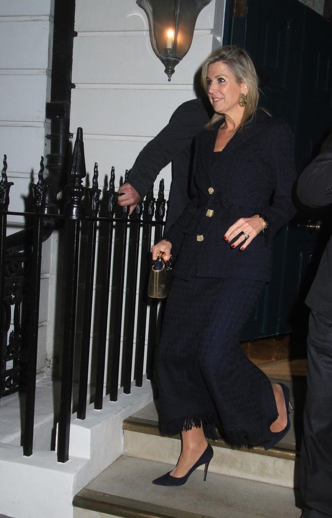 women in skirt suit walking down steps 