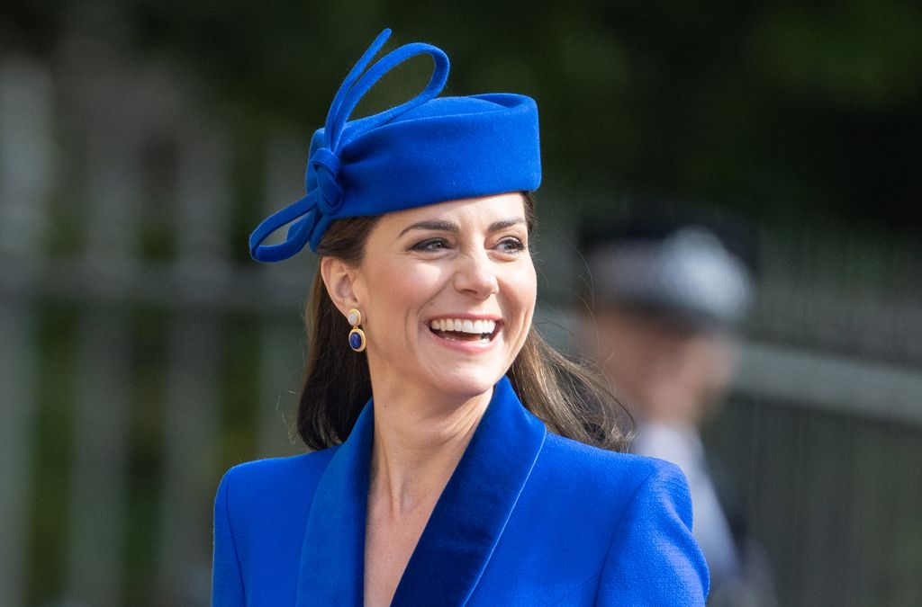 Kate Middleton smiling wearing blue hat and coat