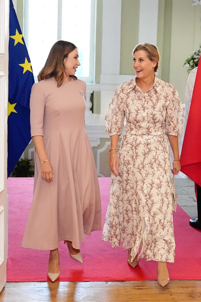 two women talking inside palace 