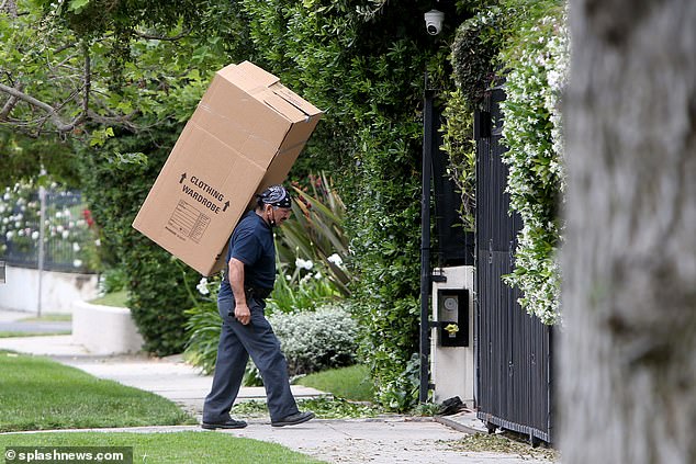 Boxes labelled 'wardrobe,' a baby chair and pink cushions were just some of the possessions seen