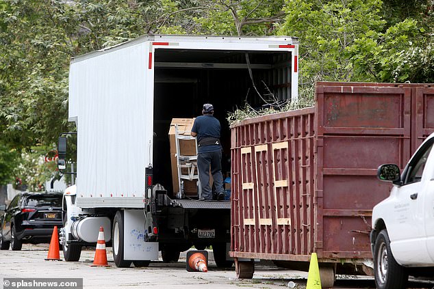 A mover is seen continuing to pack after Sharon leaves for the shops