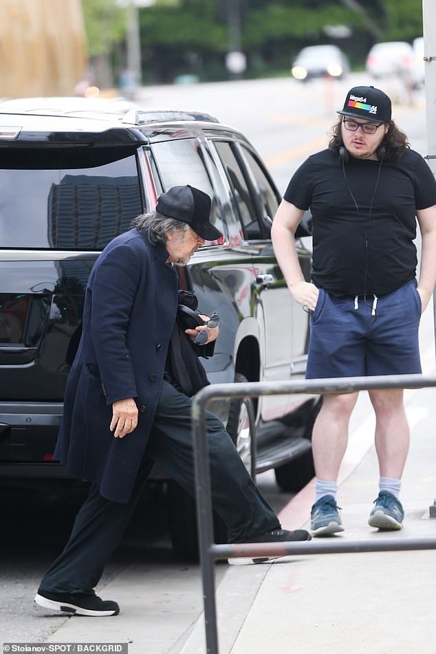 22-year-old James appeared to watch his father carefully step onto the curb as they made their way into the cinema