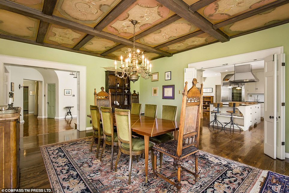 The formal dining room features an originally painted ceiling very much reminiscent of Disney's earlier fairytale films