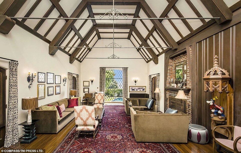 A family living room overlooks the backyard and is adorned with antiques and detailed original-era Disney relics. The furniture is richly colored and inviting, and the lead-lined windows are in their original form