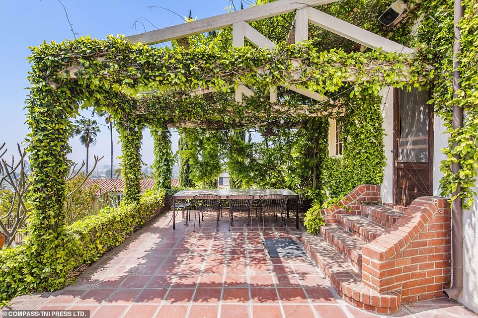 Also in the backyard is a deck area shaded by vines, where occupants of the 6,400-square-foot home may choose to dine alfresco