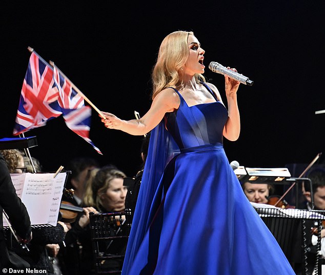 High glamour: The structured top half of her dress, with a florentine neckline, gave way to a full skirt in a shimmering blue fabric