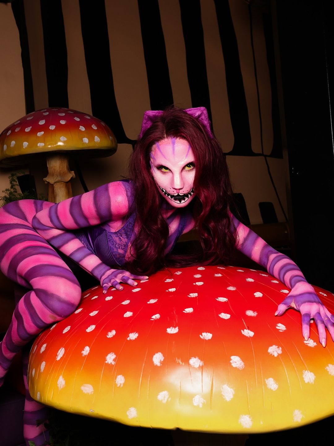 Alix Earle poses on a giant mushroom at her Halloween Party