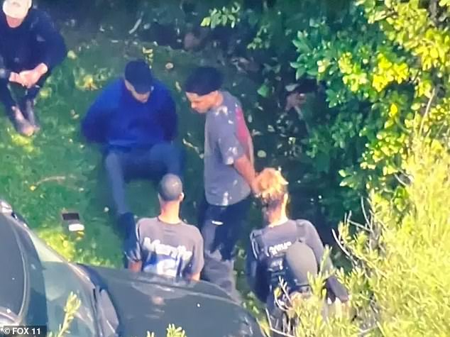 Photos show at least two men, reportedly King and Justin Combs, were seen put in handcuffs during the Los Angeles raid