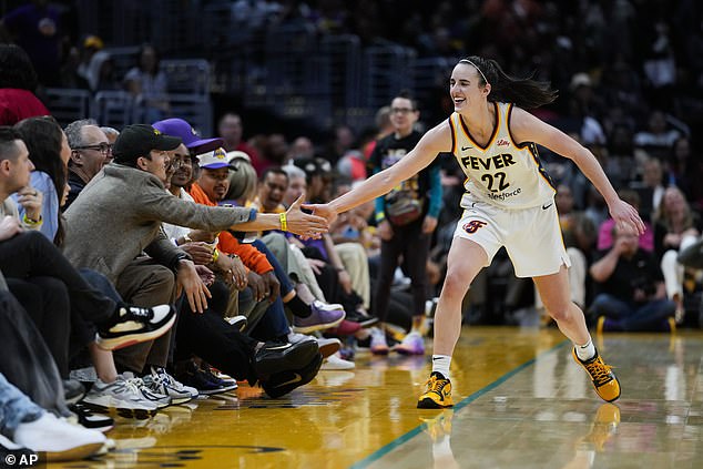 During the game, Kutcher was seen extending his hand to Clark for a high five after she drained a shot