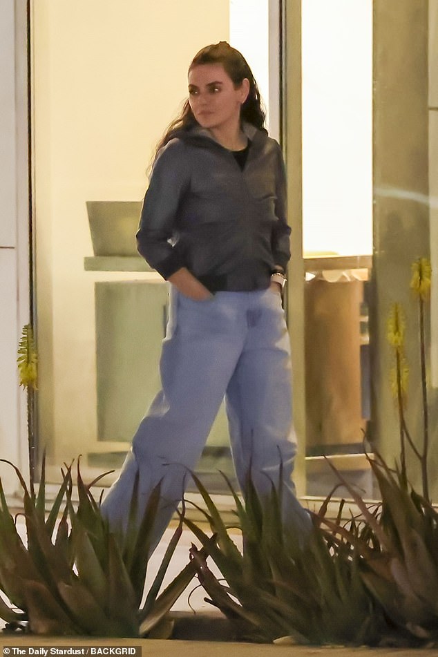 Kunis was in a green jacket with acid-washed jeans as she had her hair partially up