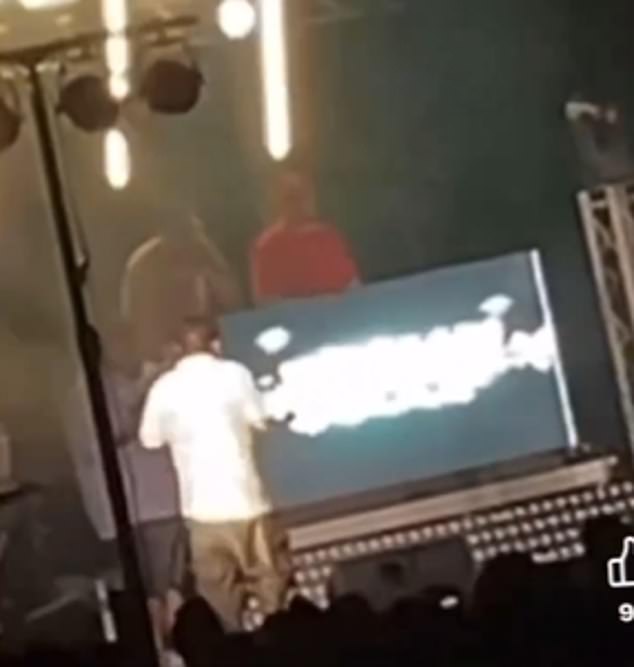 Footage from the audience captured the moment the adored rapper collapsed behind a DJ booth, which came seconds after he roused the crowd, shouting 'Let's make some noise!'
