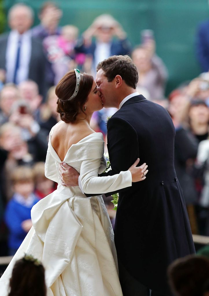 married couple kissing on wedding day 