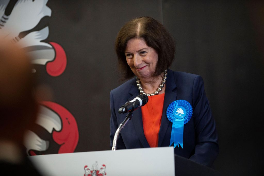 Jo Gideon at a podium giving a victory speech