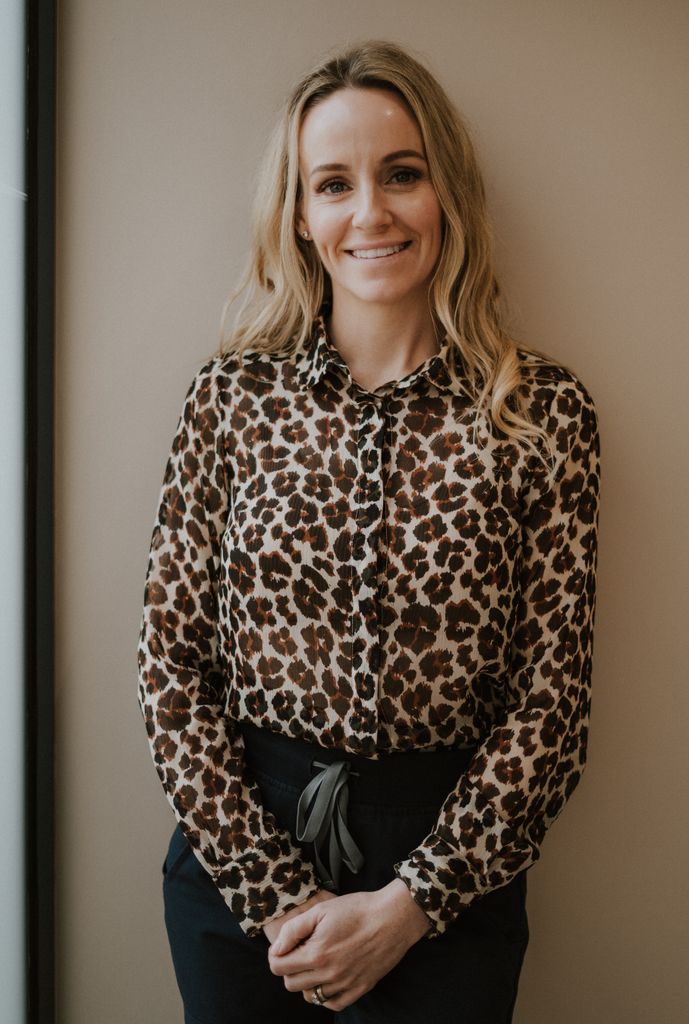 Woman smiling in a leopard print top