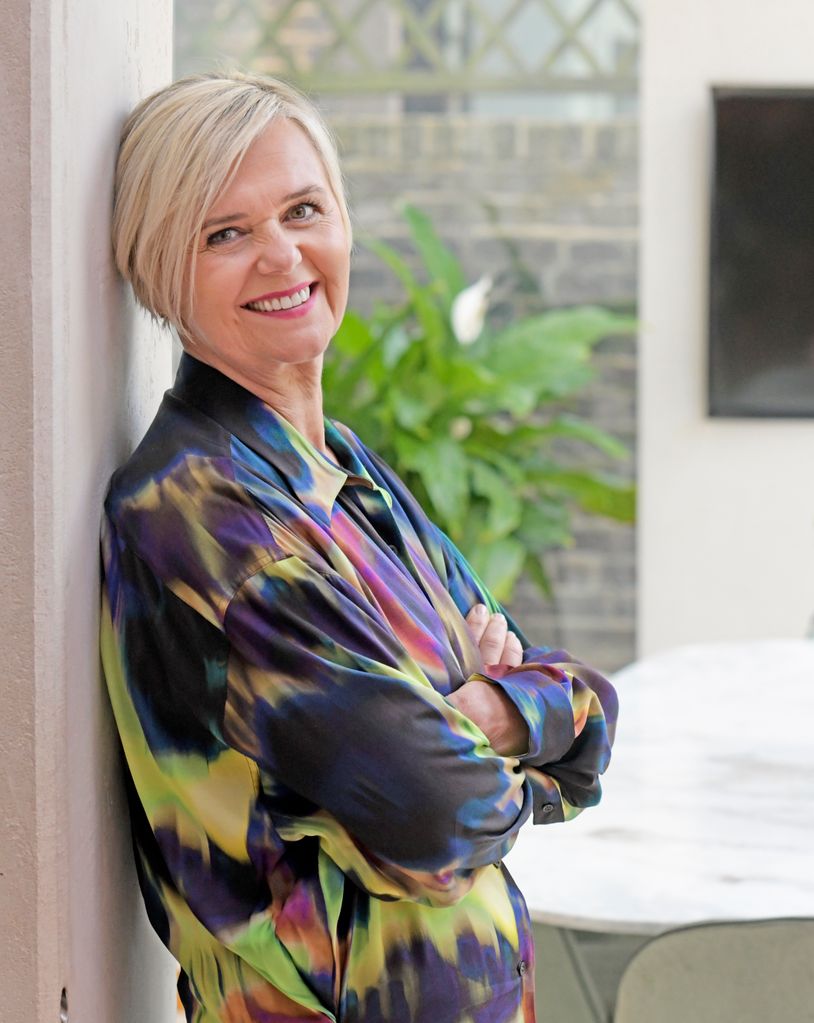 smiling woman in printed shirt