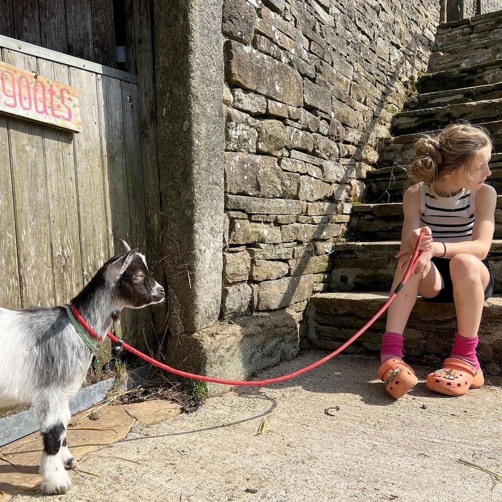 Amanda Owen's daughter with a goat