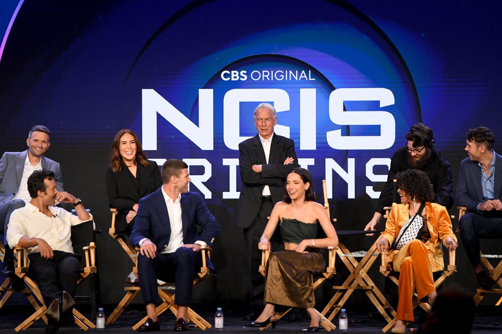 David J. North, Kyle Schmid, Gina Lucita Monreal, Austin Stowell, Mark Harmon, Mariel Molino and Sean Harmon speak onstage at the "NCIS: Origins" Presentation Q&A during the CBS Network portion of the 2024 TCA Summer Press Tour at The Langham Huntington, Pasadena on July 13, 2024 in Pasadena, California