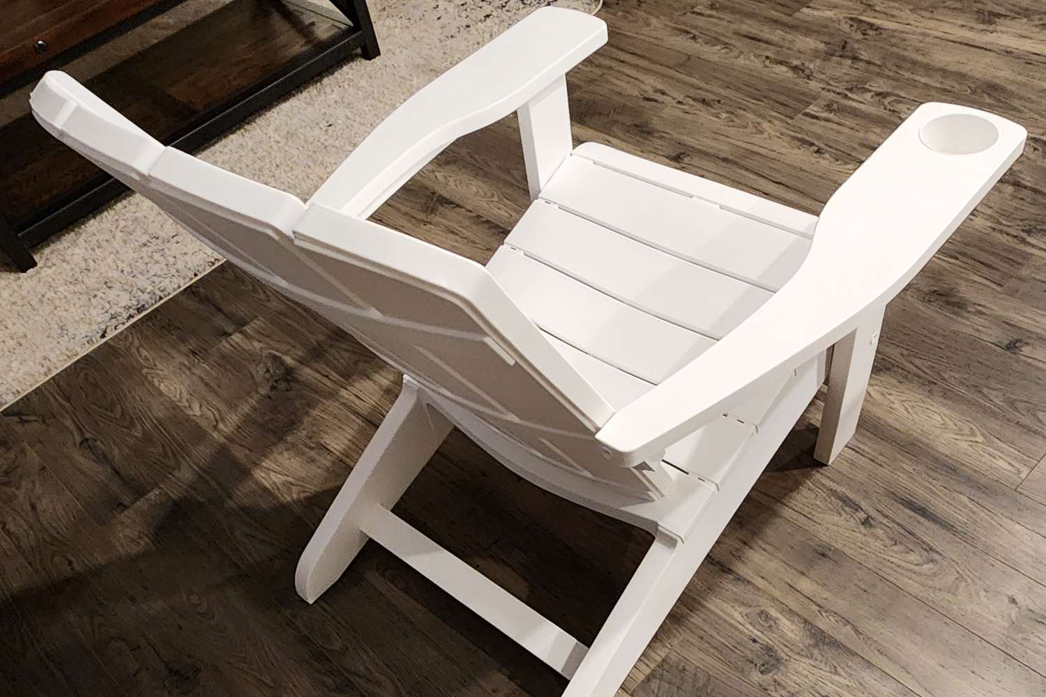 An assembled Keter Alpine Adirondack Chair on wood