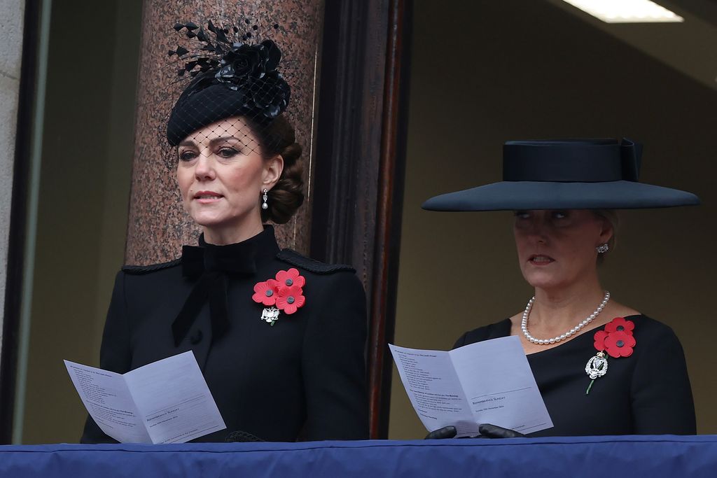 two women singing from hymn sheet