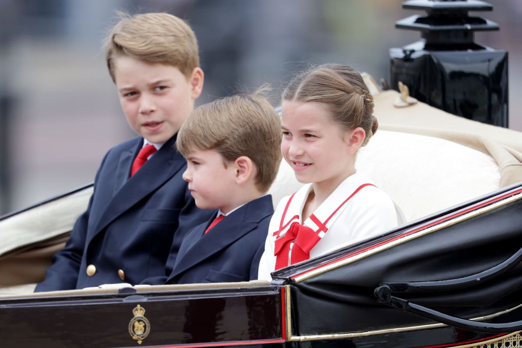 three children riding in carriage