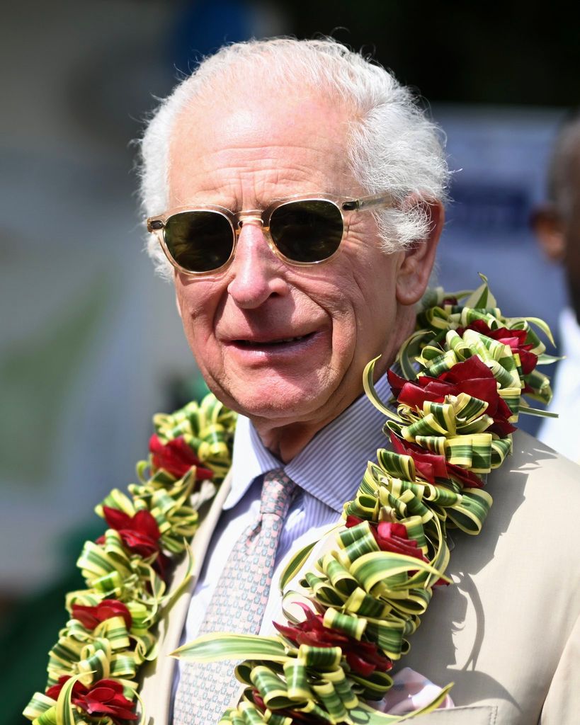 King Charles wearing sunglasses and lei in Samoa