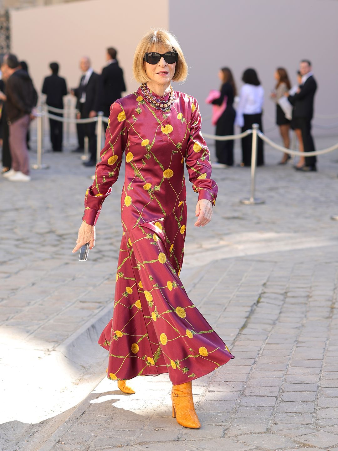 anna wintour in marroon printed dress