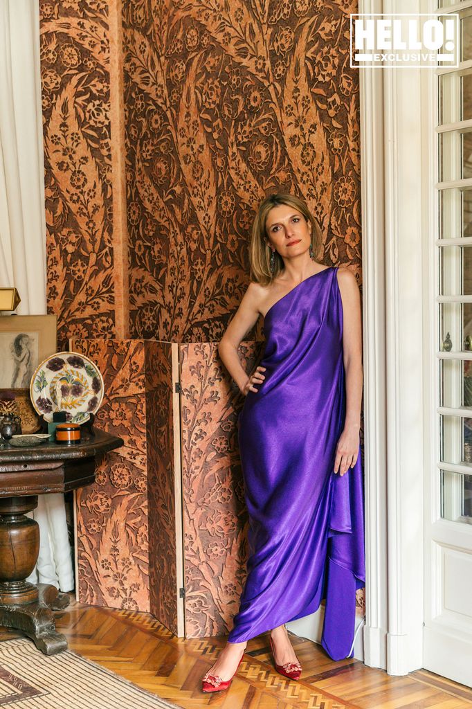 Martina Mondadori posing in purple dress at home in Milan 