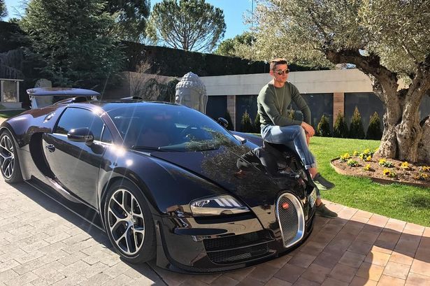 Cristiano Ronaldo sitting on bonet of car