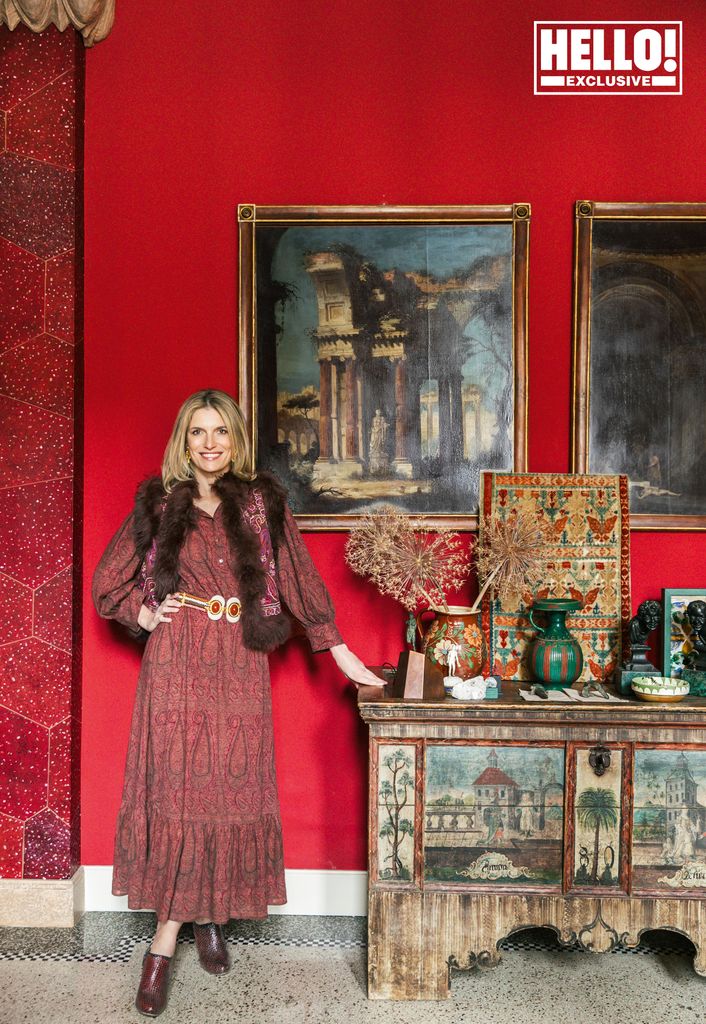 Martina Mondadori in red dress posing at home in Milan 