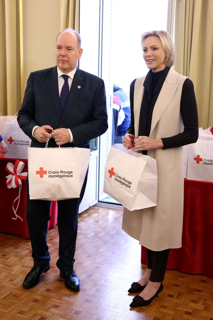 Prince Albert and Princess Charlene holding bags