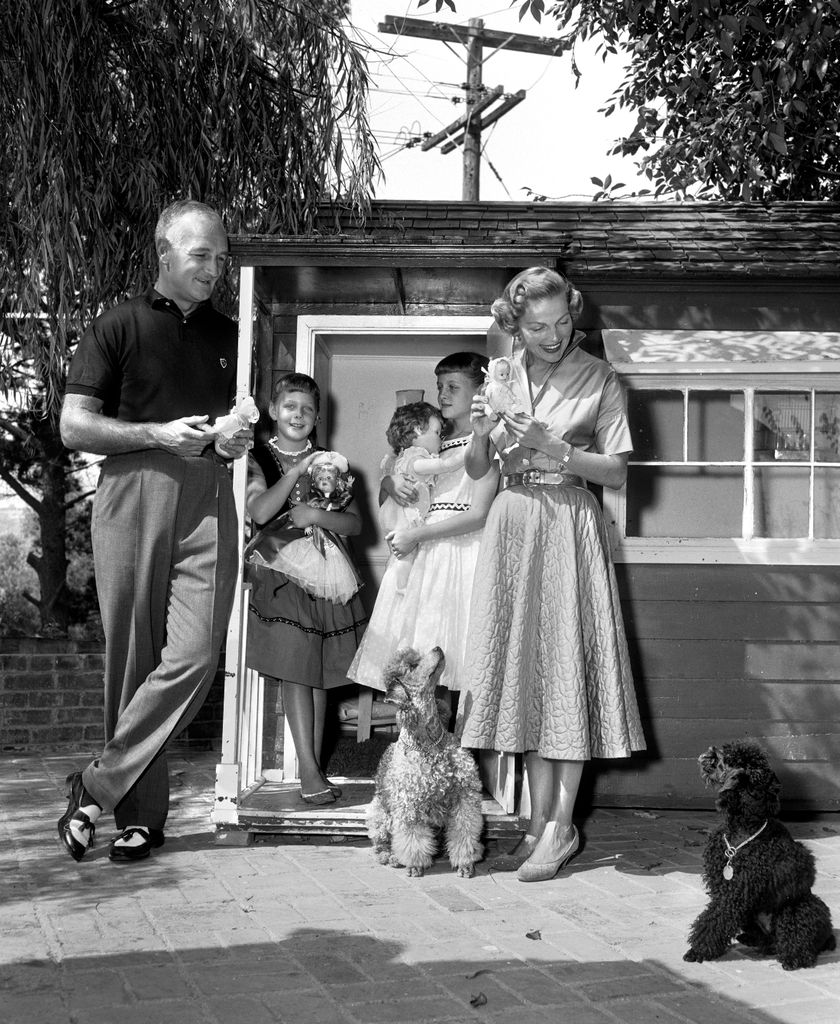 Tom Harmon, retired professional football player, a KNX / CBS sportscaster. Relaxes at home and with his family. From left is Tom Harmon; daughter, Kelly Harmon; daughter, Kristin Harmon; wife, Elyse Knox. September 4, 1956. Los Angeles, CA