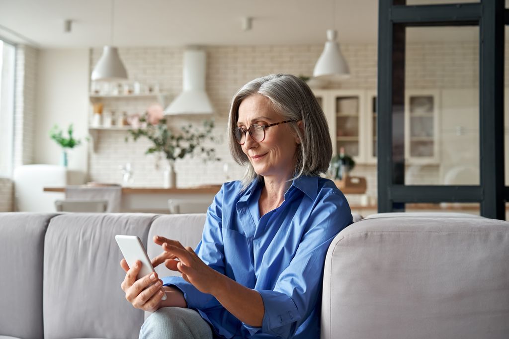 Older woman texting and smiling