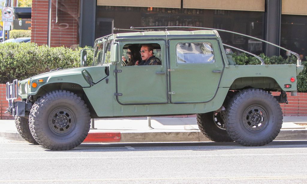 Arnold Schwarzenegger and his daughter Katherine in a Hummer