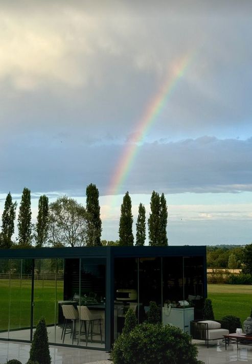 An outdoor kitchen with a rainbow in the sky