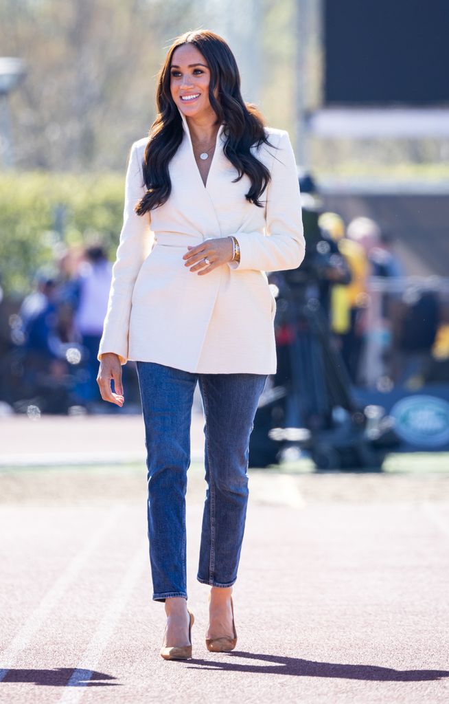 The Duchess of Sussex in jeans with a statement white blazer