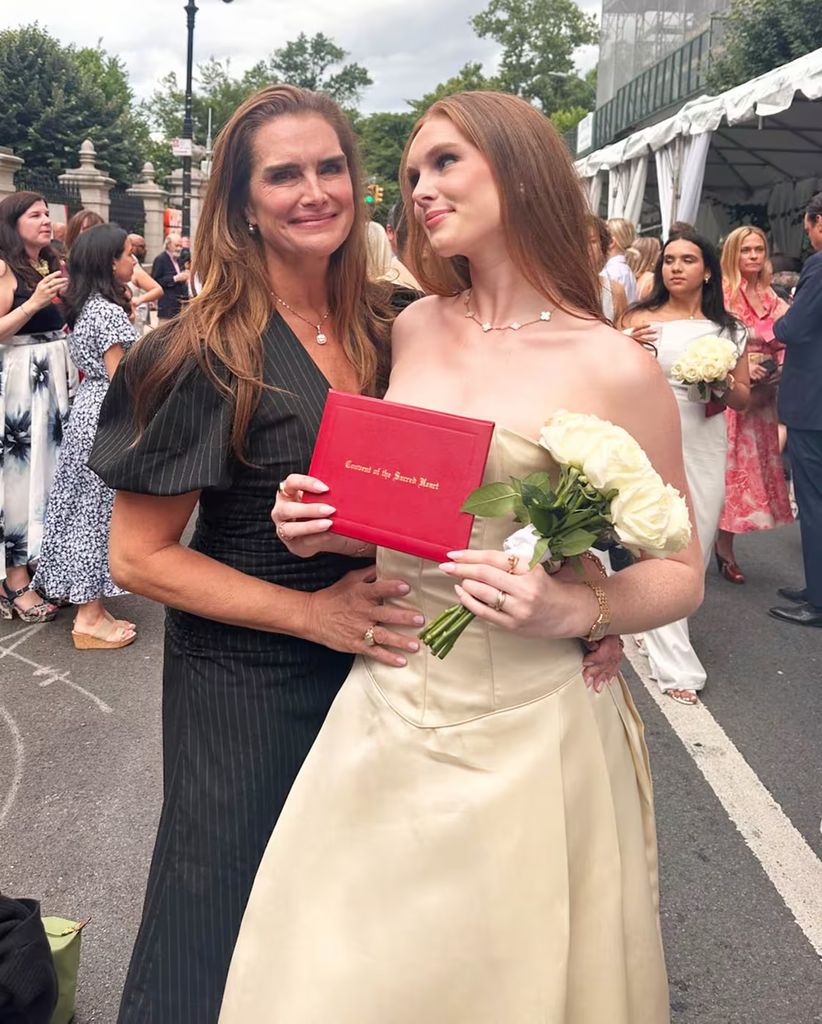 Brooke proudly poses with her daughter on her graduation day