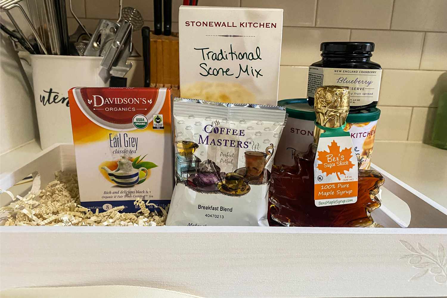 The contents of a GourmetGiftBaskets New England Breakfast Gift Basket Classic on a counter 