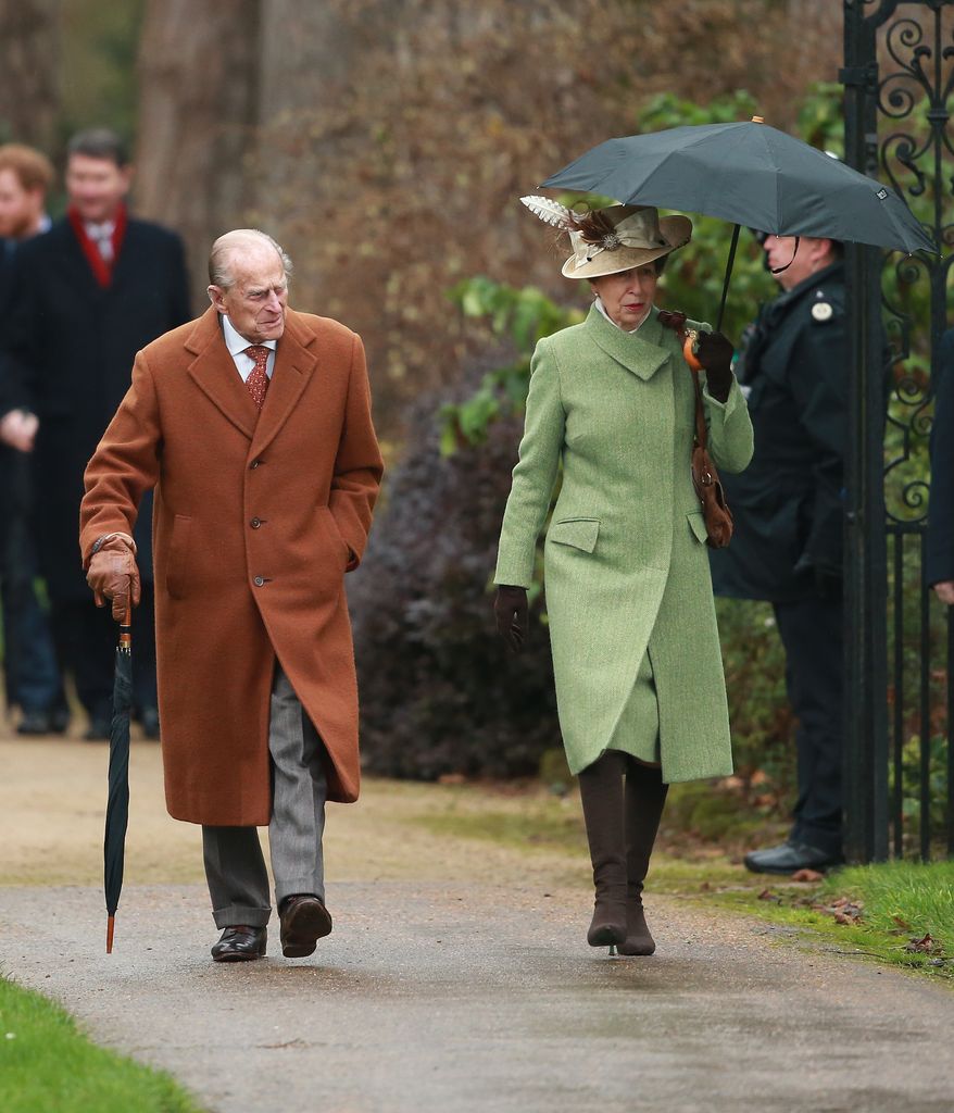 Prince Philip and Princess Anne in coats walking