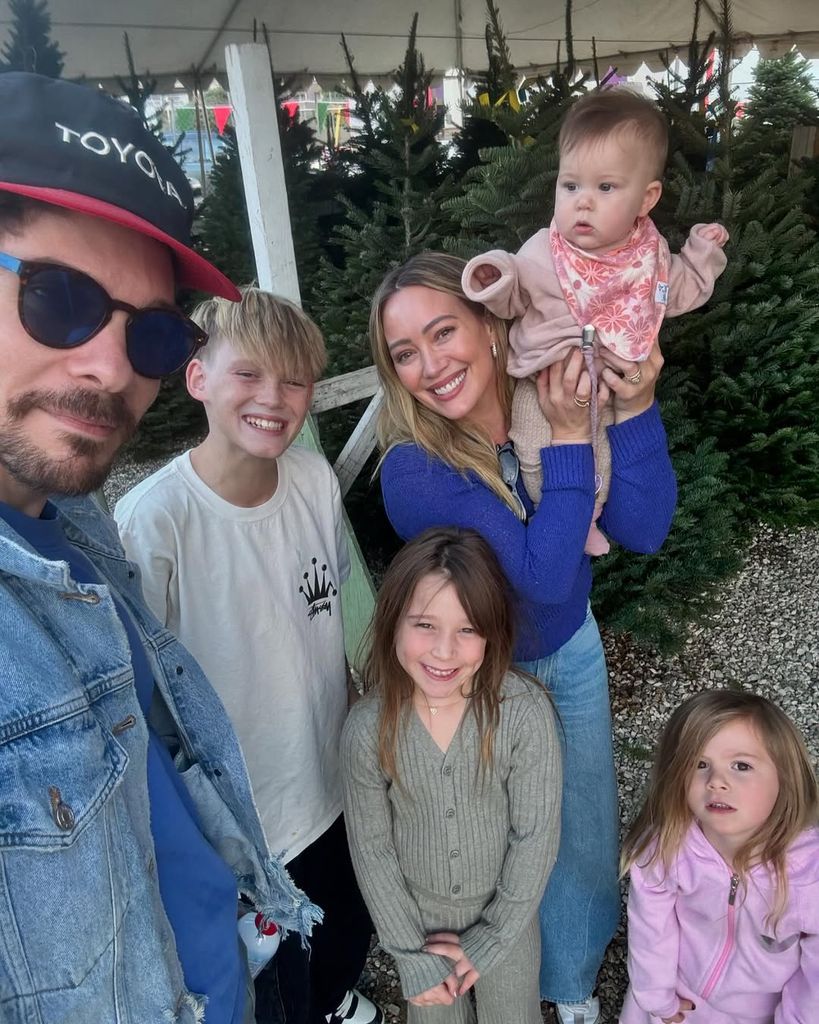 Hilary Duff poses with her husband Matthew and four children