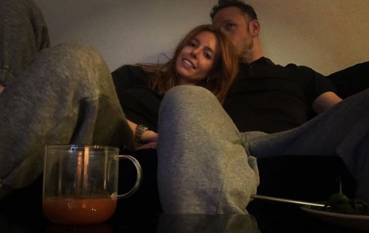 Stacey Dooley being kissed by Kevin Clifton on a sofa