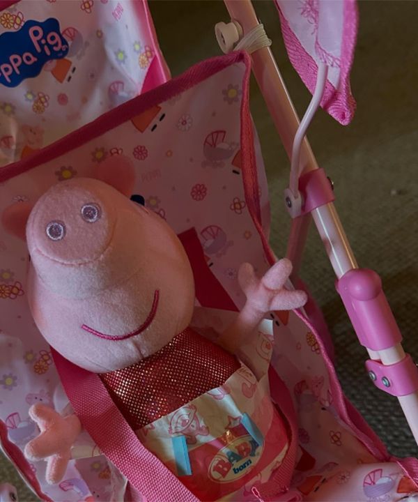 A Peppa Pig toy in a buggy