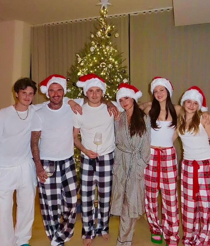 Cruz, David, Brooklyn, Victoria and Harper Beckham with Nicola Peltz in matching pyjamas at Christmas