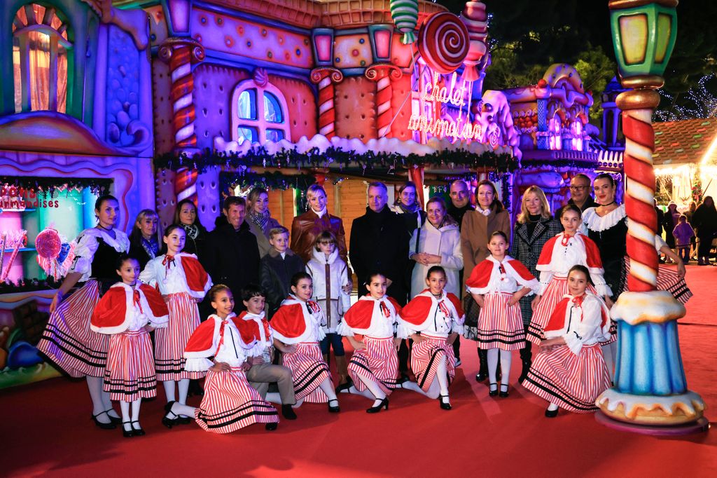 Princess Charlene  surrounded by kids in christmas outfits 