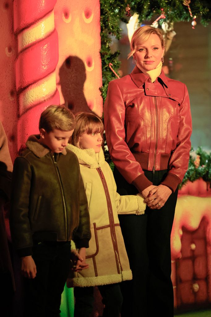 Princess Charlene of Monaco stands next to her children Princess Gabriella and Prince Jacques in leather jacket